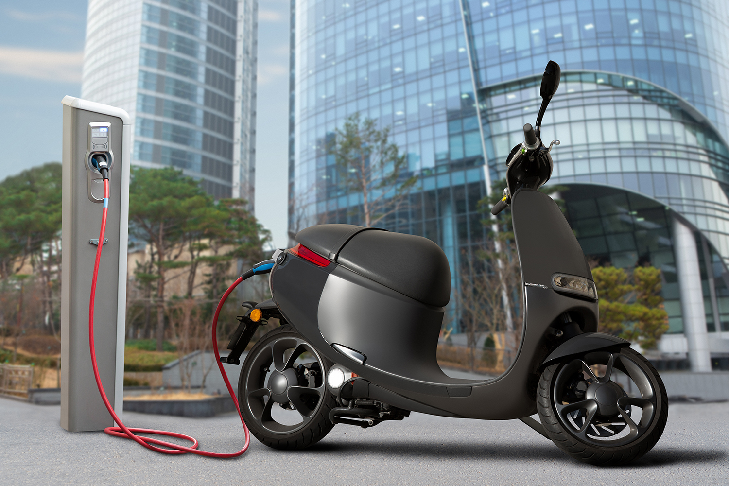 Image of micro-mobility vehicle; EV scooter plugged in. 